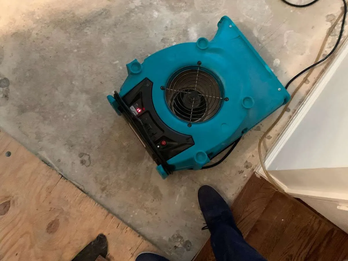 Air mover drying subfloor during Commercial Water Damage Restoration in Boynton Beach